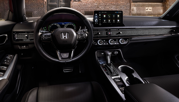 Interior panoramic view of the windshield on a Hatchback parked in front of brick wall in an old warehouse district.