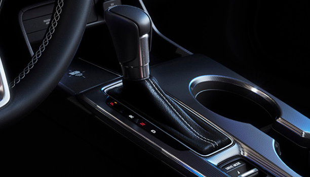 Closeup of a gearshift in the cabin of a hatchback