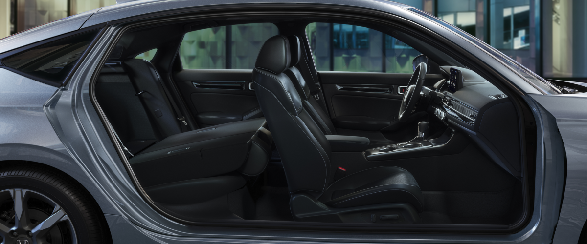 Side view of hatchback with door open at night.