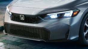 3/4 closeup of the front of a grey Hatchback.