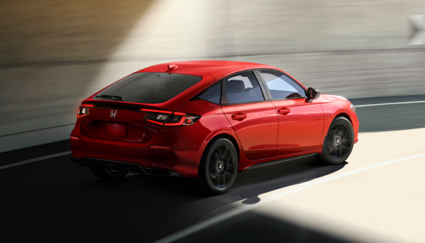 Rear view of grey Hatchback driving on a city street. 