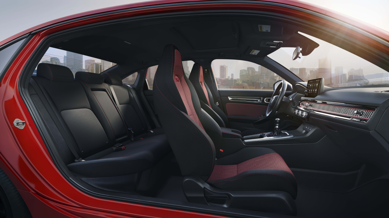 Wide side view of Civic Si with no doors, showcasing its two rows of seating.