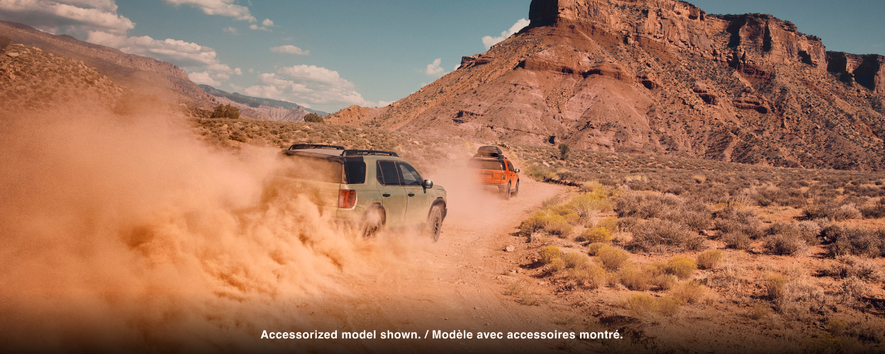 A grey Passport drives through dusty desert terrain.