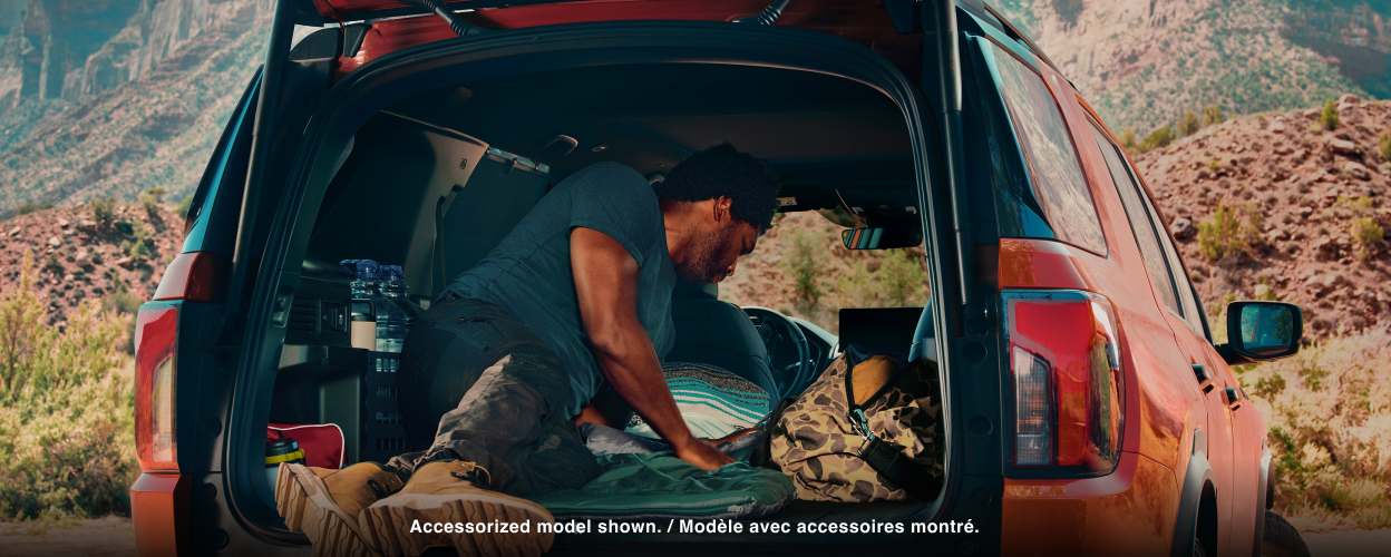Rear-view of an open door showing camping gear. 