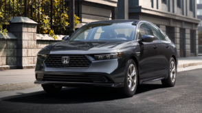 3/4 front view of a grey Accord parked curbside in an upscale urban neighbourhood in the day.