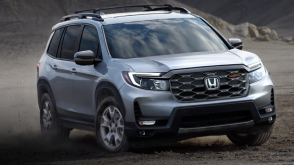 3/4 front view of grey Passport off-roading in desert.