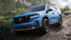 3/4 front view of grey Passport off-roading in desert.