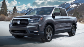 3/4 front view of grey Ridgeline in the snowy outdoors.